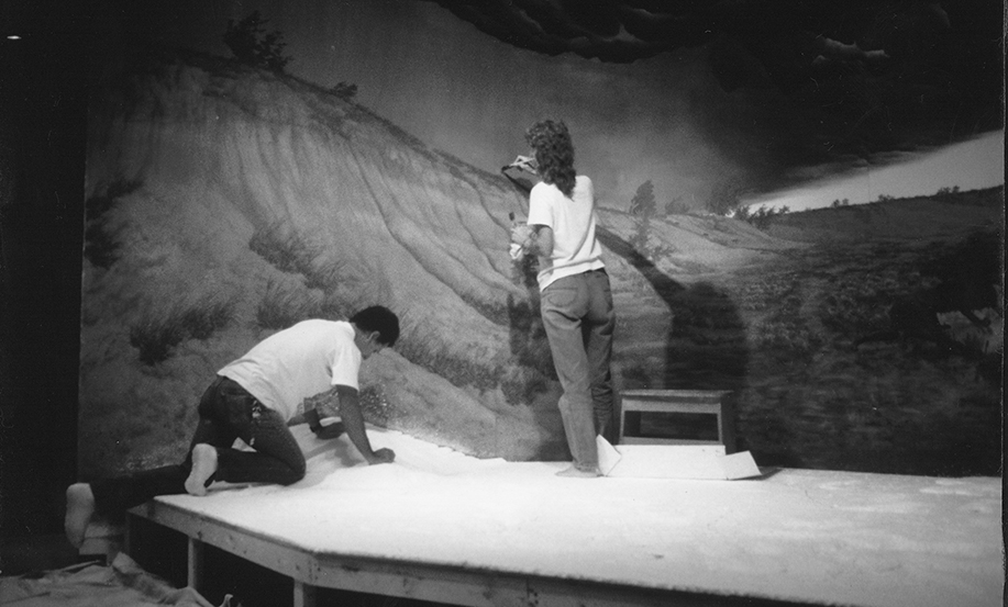 Staff painting an exhibit diorama